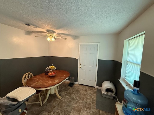 809 Michelle Dr, Copperas Cove, TX 76522 - dining space featuring a textured ceiling, stone finish flooring, ceiling fan, and visible vents
