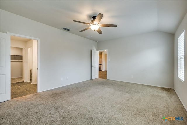 772 Armadillo Dr, Seguin, TX 78155 - unfurnished bedroom with visible vents, carpet flooring, freestanding refrigerator, and a walk in closet