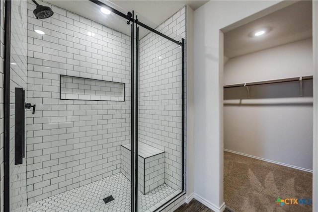 772 Armadillo Dr, Seguin, TX 78155 - bathroom with a walk in closet, baseboards, and a stall shower