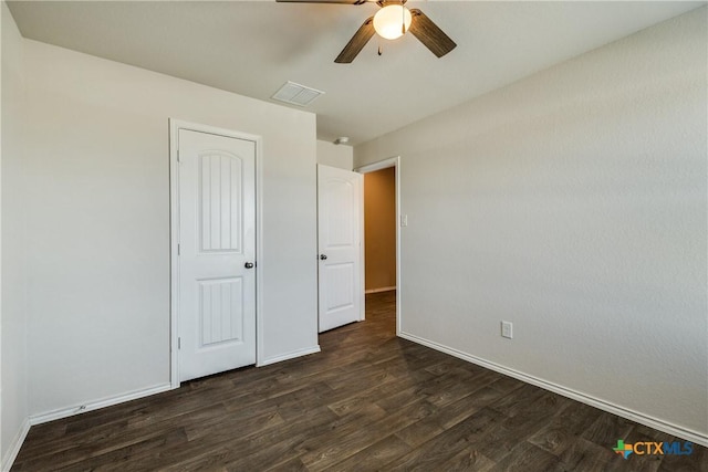 772 Armadillo Dr, Seguin, TX 78155 - unfurnished bedroom featuring dark wood finished floors, visible vents, baseboards, and ceiling fan