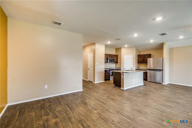 772 Armadillo Dr, Seguin, TX 78155 - kitchen featuring open floor plan, dark wood-style floors, visible vents, and appliances with stainless steel finishes