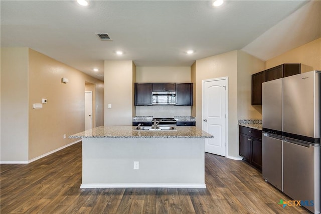 772 Armadillo Dr, Seguin, TX 78155 - kitchen featuring dark brown cabinets, visible vents, appliances with stainless steel finishes, and a sink