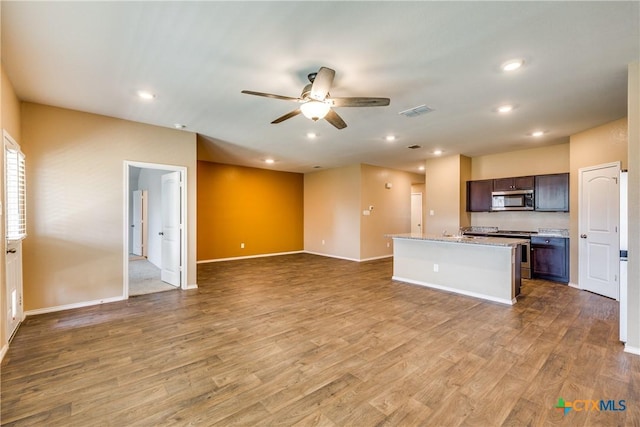 772 Armadillo Dr, Seguin, TX 78155 - unfurnished living room with a ceiling fan, recessed lighting, wood finished floors, and visible vents