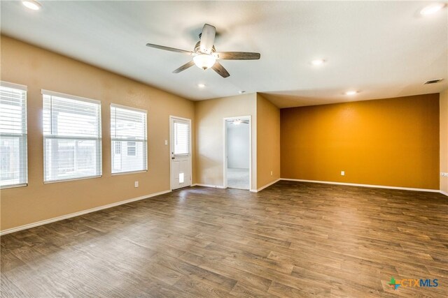 772 Armadillo Dr, Seguin, TX 78155 - unfurnished room featuring visible vents, a healthy amount of sunlight, a ceiling fan, and wood finished floors