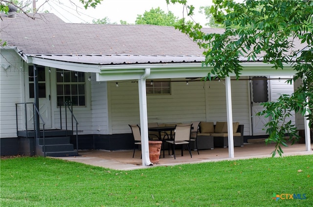 rear view of property featuring a lawn, a patio, an outdoor hangout area, and metal roof