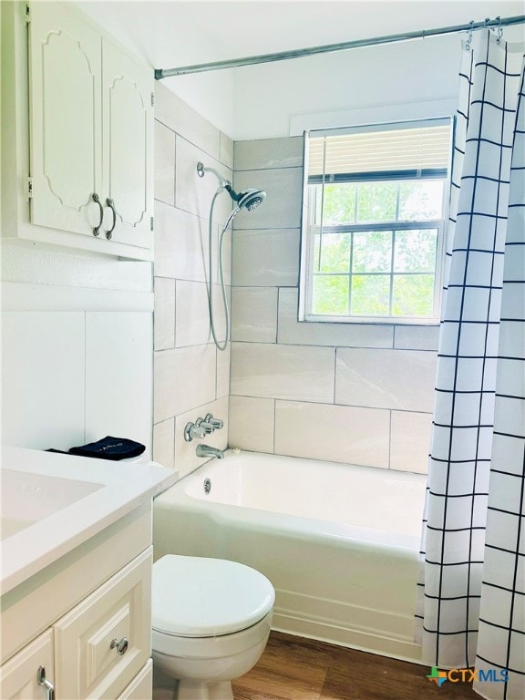 bathroom with shower / bath combination with curtain, wood finished floors, toilet, and vanity