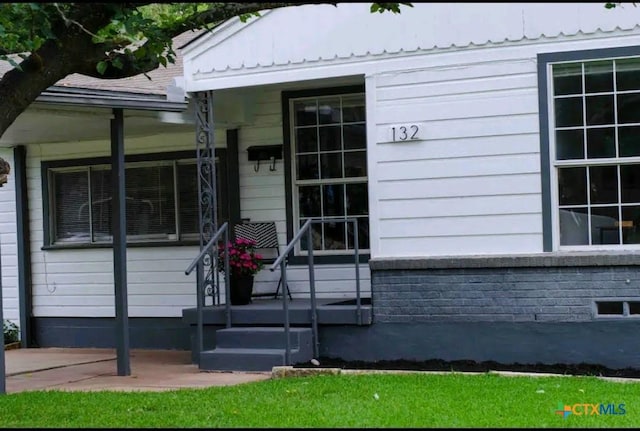 entrance to property featuring metal roof