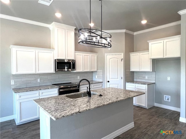 913 Antelope Trl, Temple, TX 76504 - kitchen with stainless steel microwave, a sink, electric stove, ornamental molding, and decorative backsplash