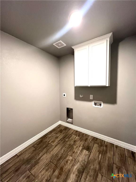 913 Antelope Trl, Temple, TX 76504 - washroom featuring electric dryer hookup, dark wood-type flooring, baseboards, and hookup for a washing machine