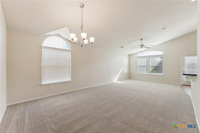 empty room featuring light colored carpet, baseboards, ceiling fan with notable chandelier, and vaulted ceiling