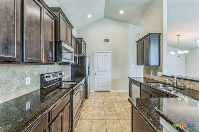 kitchen with dark stone counters, stainless steel appliances, visible vents, and dark brown cabinets