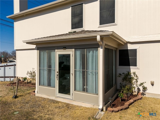 exterior space with a sunroom and stucco siding