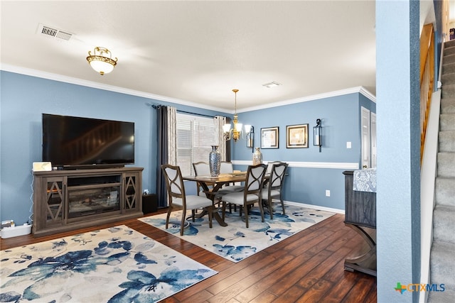 dining area with visible vents, stairway, hardwood / wood-style floors, and ornamental molding