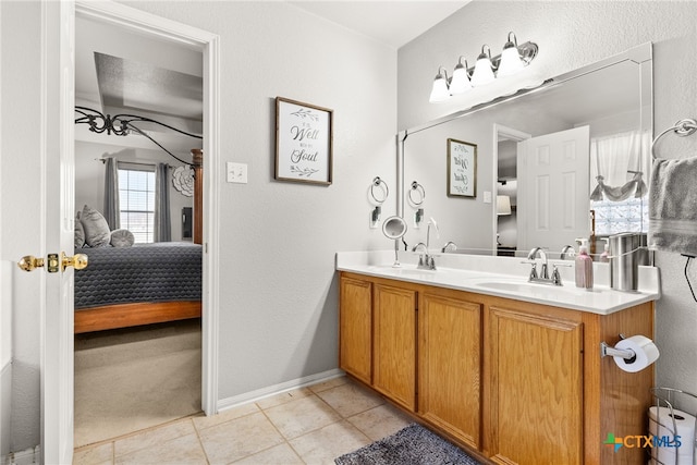 ensuite bathroom with tile patterned flooring, double vanity, a sink, and ensuite bathroom