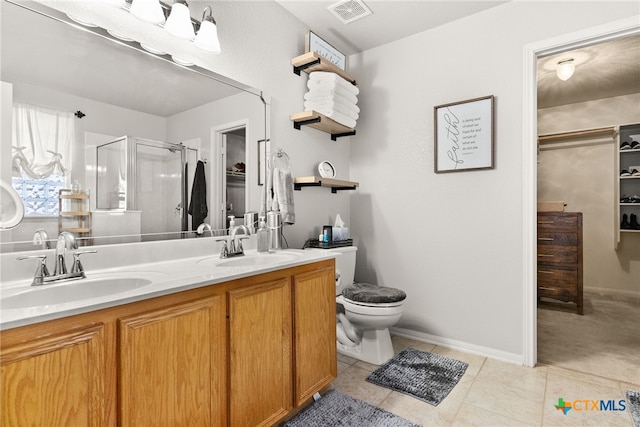 bathroom with visible vents, a sink, a shower stall, and double vanity