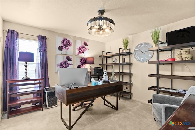 carpeted office space featuring a chandelier, a textured ceiling, and baseboards