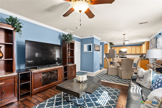 living room with visible vents, ornamental molding, dark wood-type flooring, ceiling fan, and a textured ceiling