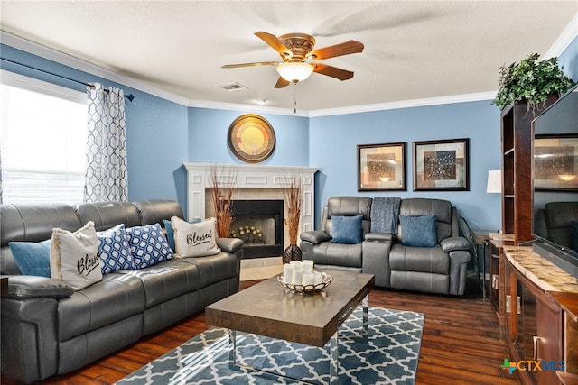 living area featuring crown molding, visible vents, a high end fireplace, ceiling fan, and wood finished floors