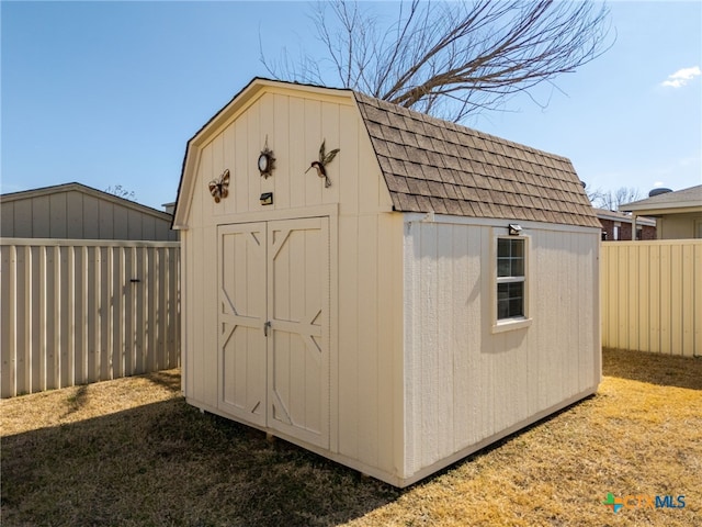 view of shed with a fenced backyard