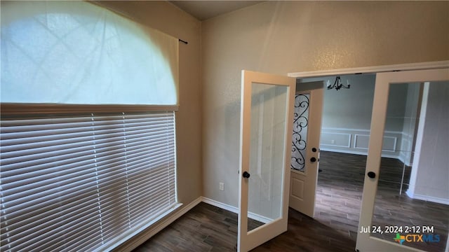 detailed view of wood finished floors and a chandelier