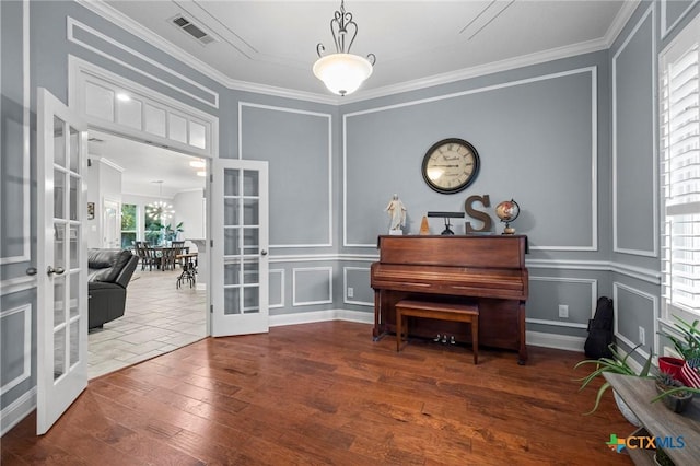 408 O W Lowrey, Salado, TX 76571 - living area with french doors, a decorative wall, crown molding, and hardwood / wood-style floors