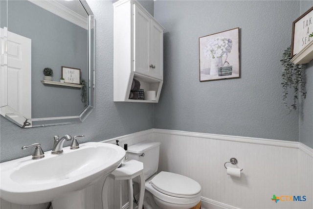 408 O W Lowrey, Salado, TX 76571 - bathroom with a sink, toilet, and a wainscoted wall