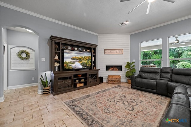 408 O W Lowrey, Salado, TX 76571 - living room featuring ceiling fan, arched walkways, baseboards, ornamental molding, and a large fireplace