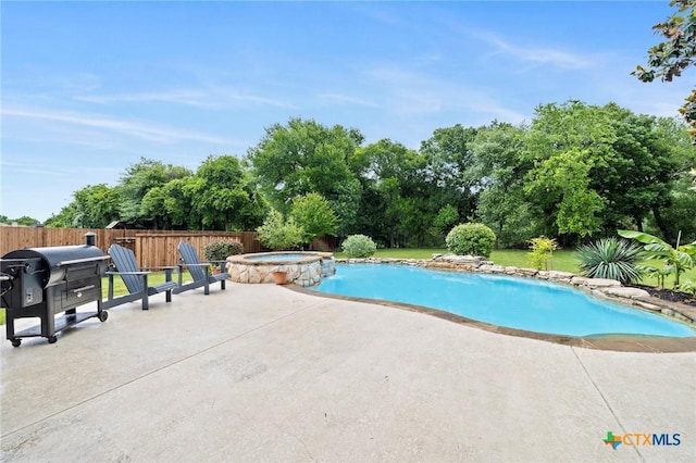 408 O W Lowrey, Salado, TX 76571 - view of pool with a patio, a pool with connected hot tub, fence, and view of wooded area
