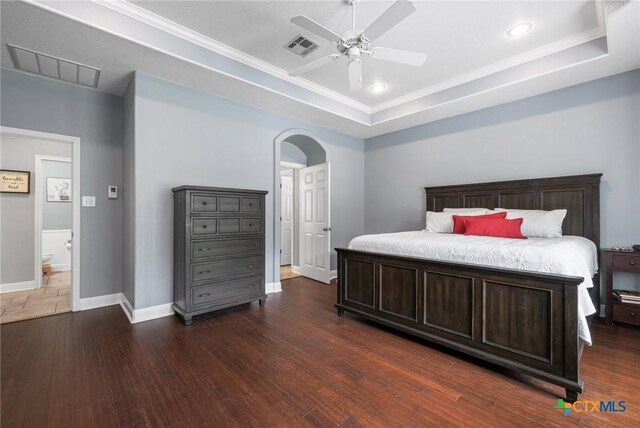 408 O W Lowrey, Salado, TX 76571 - bedroom with baseboards, arched walkways, wood finished floors, a tray ceiling, and ceiling fan