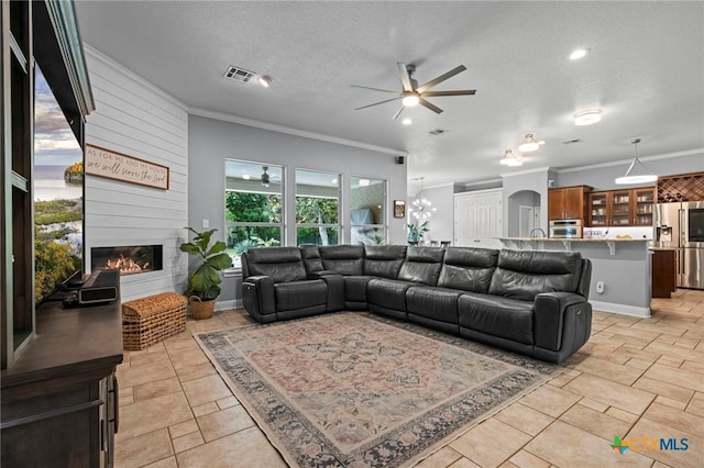 408 O W Lowrey, Salado, TX 76571 - living area with a ceiling fan, ornamental molding, a large fireplace, a textured ceiling, and baseboards