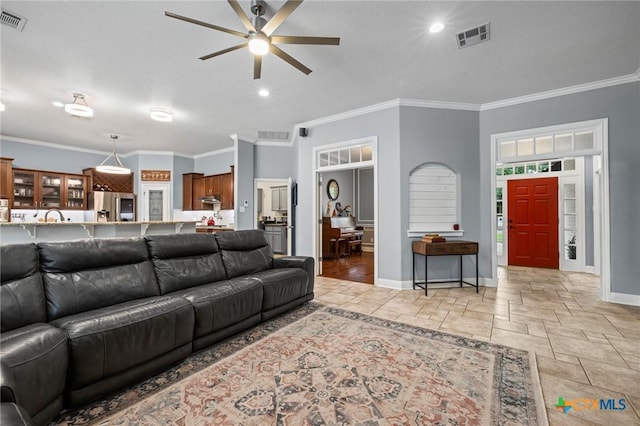 408 O W Lowrey, Salado, TX 76571 - living area with a ceiling fan, baseboards, stone tile floors, and crown molding