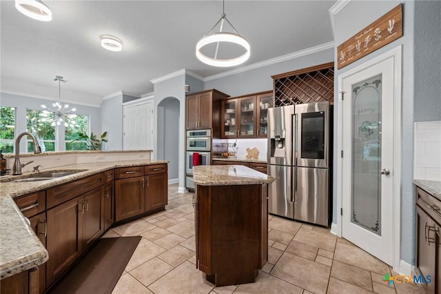 408 O W Lowrey, Salado, TX 76571 - kitchen with stainless steel appliances, a sink, ornamental molding, a kitchen island, and pendant lighting