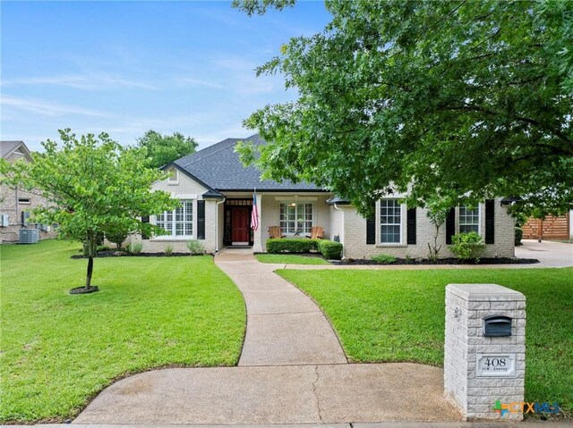 408 O W Lowrey, Salado, TX 76571 - view of front of property featuring a front lawn, brick siding, and cooling unit