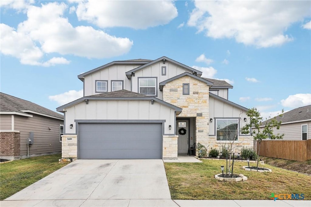 view of front of property with a garage and a front lawn