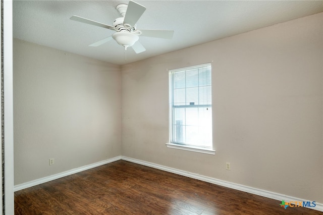 unfurnished room with ceiling fan and dark hardwood / wood-style floors