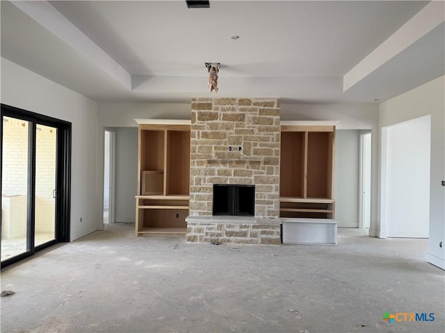 1242 Ambrose Dr, Salado, TX 76503 - unfurnished living room featuring a tray ceiling and a stone fireplace