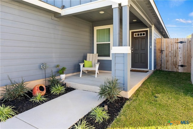 property entrance with a yard and a patio