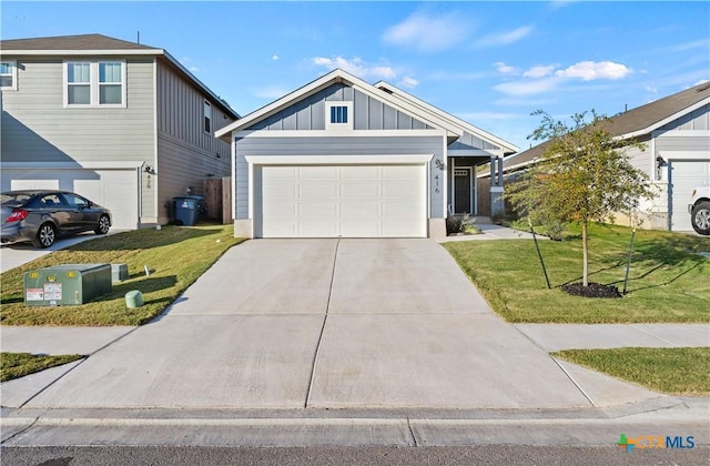 view of front of property featuring a garage and a front lawn