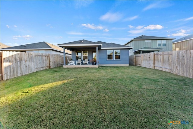 back of property featuring a patio and a lawn