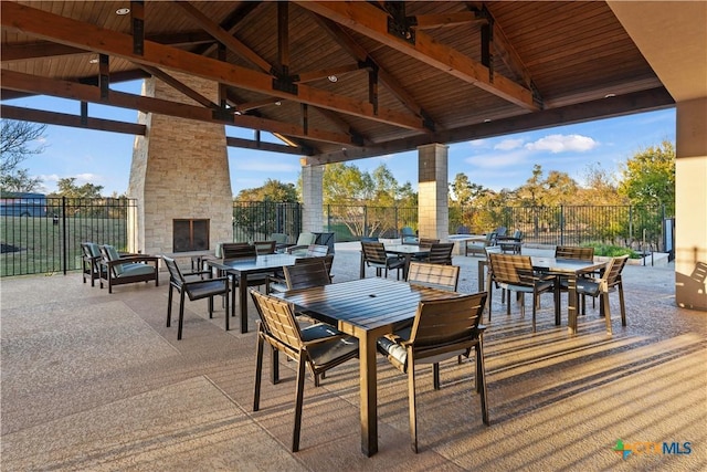 view of patio / terrace with a gazebo and an outdoor stone fireplace