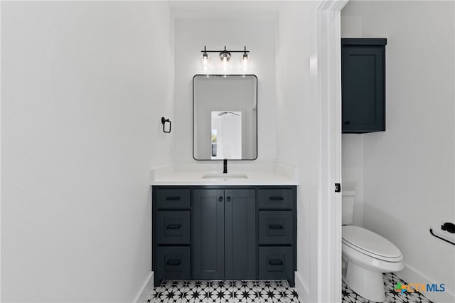 bathroom with tile patterned floors, vanity, and toilet