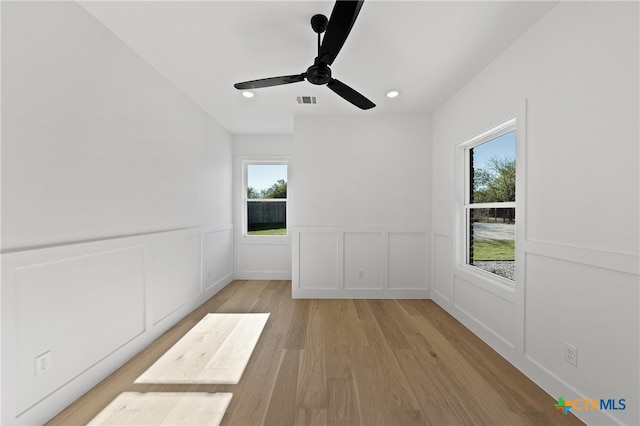 unfurnished room with ceiling fan and light hardwood / wood-style flooring