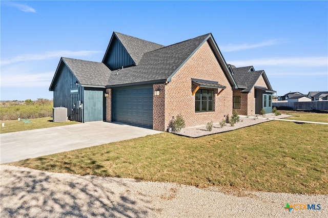 view of front of property featuring central AC unit, a garage, and a front yard