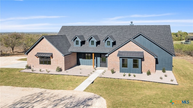 view of front of house with covered porch and a front lawn