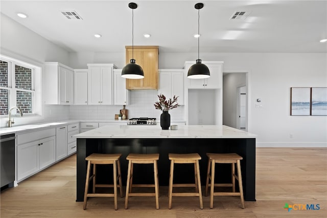 kitchen featuring white cabinetry and a kitchen island