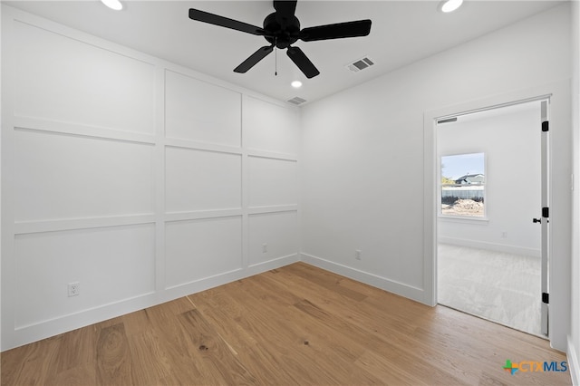 spare room with light hardwood / wood-style floors and ceiling fan