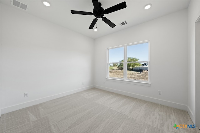 spare room with light carpet and ceiling fan