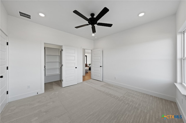 unfurnished bedroom with ceiling fan, a closet, and light colored carpet