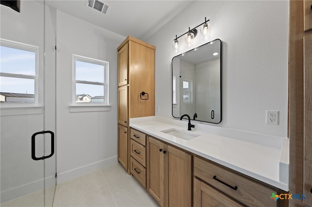 bathroom with vanity, tile patterned floors, and walk in shower