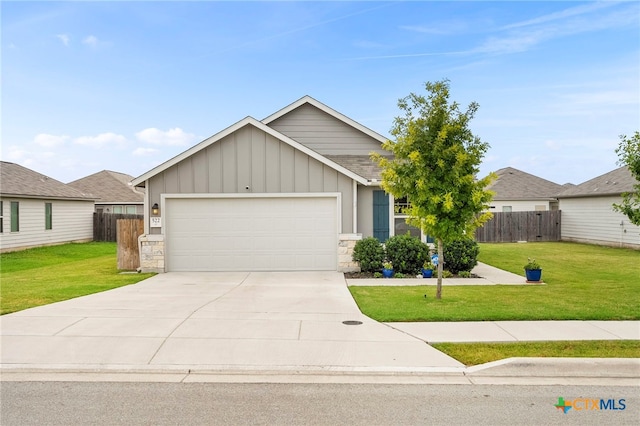 view of front of property featuring a garage and a front lawn